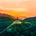sitting budha statue on temple at the center of forest